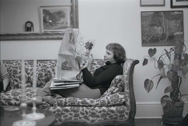 Corky reading the Times in the living room.