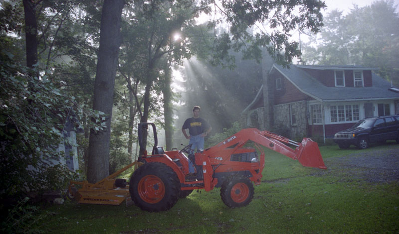 On the tractor, in sun rays.   Photo by Alissa.